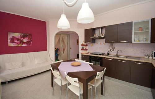 a kitchen and dining room with a table and chairs at Cozy Apartment In Santa Croce Camerina in Santa Croce Camerina