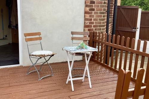 two chairs and a table on a porch at Lorton Villa with a Log Burner in Saint Helens