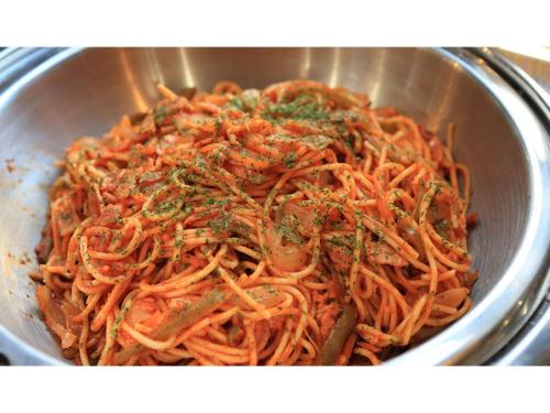 a metal bowl filled with spaghetti with green herbs at Smile Hotel Kumamoto Suizenji - Vacation STAY 73087v in Kumamoto