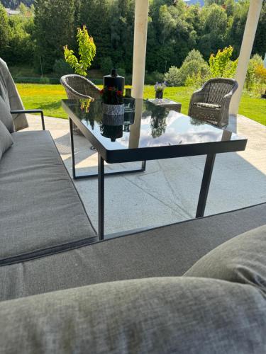 a glass coffee table sitting on a patio at Comfort Apartment in Lone Only 20 minutes away from the heart of the city! in Bergen