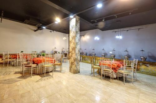 a room with a table and chairs and a room with tables and chairs at Hotel Wedlock - Golf Course Extension Road in Gurgaon