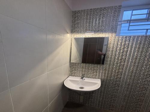 a bathroom with a sink and a mirror at Housr 36 Studio Rooms Bangalore Near Leela Palace in Bengaluru