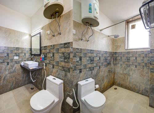 a bathroom with a toilet and a sink at Hotel Wedlock - Golf Course Extension Road in Gurgaon