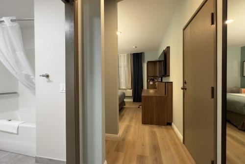 a small room with a bedroom and a bathroom at Wingate by Wyndham Farmington NM in Farmington