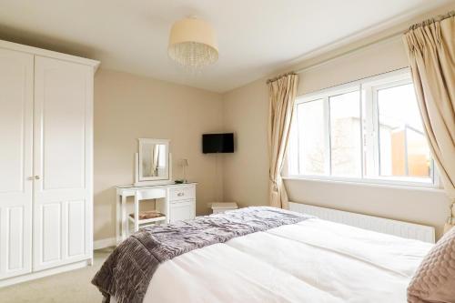 a bedroom with a white bed and a window at Sea Mist Guesthouse in Galway