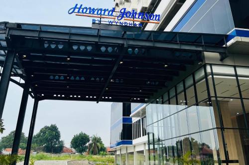 a building with a sign on top of it at Howard Johnson By Wyndham Tangerang in Tangerang