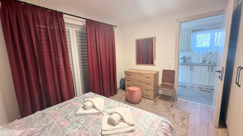 a bedroom with a bed and a dresser and a window at Harmony Home in Kouspádes
