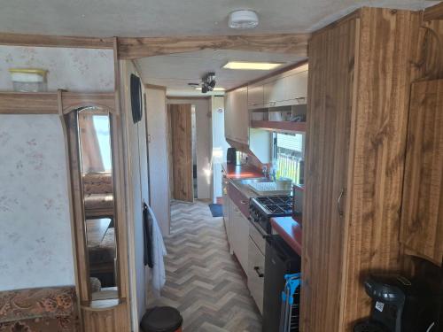 an interior view of a kitchen in an rv at Idyllic Family Holiday Caravan in Skegness