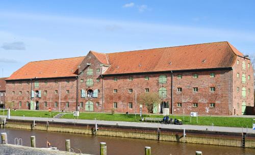 a large brick building next to a body of water at Nordfriesisches Haus in Tönning