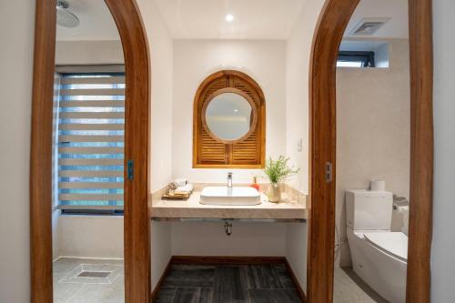 a bathroom with a sink and a mirror at Shoreline Stay in Hoi An