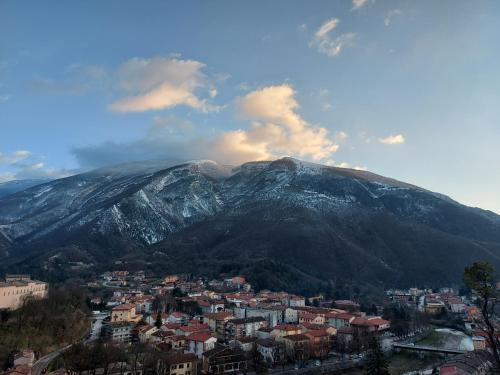 a mountain with a town in front of a city at Agriturismo Cardella in Piobbico