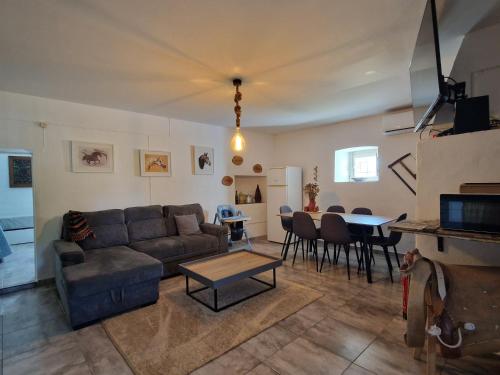 a living room with a couch and a table at Monte das Cobras - Country House in Évora