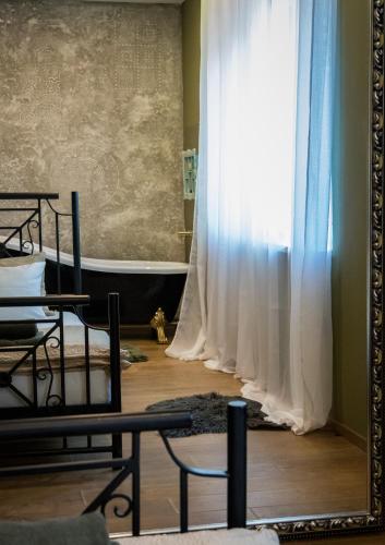 a room with white curtains and a mirror at Čista desetka! - sa garažnim mestom in Novi Sad