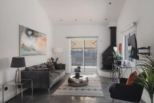 a living room with a couch and a table at Botanical Art House by Staycom in Paphos City