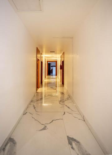 an empty hallway with marble floors and walls at Casino Hotels Ltd in Trichūr