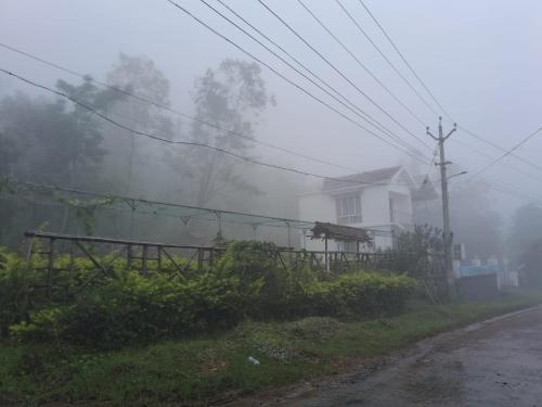 a house on the side of a road in the fog at LoveNest by ClubTravalet in Kanthalloor