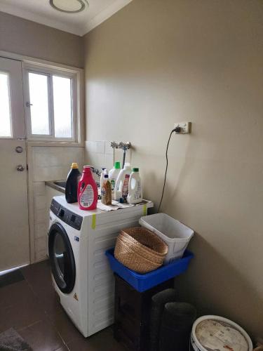 a laundry room with a washing machine and a window at 81B Ridge Drive in Albion