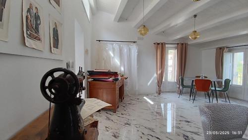 a living room with a table and chairs in it at La Locanda del Sarto in Belmonte Calabro