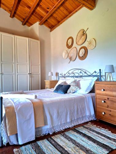 a bedroom with a bed and a wooden ceiling at Aga's Seaview Cottages in Ágios Márkos