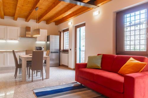 a living room with a red couch and a table at Villa Belvedere in Settimo