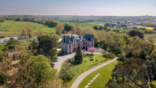 an aerial view of a mansion in a field at Château Hôtel Du Colombier in Saint Malo