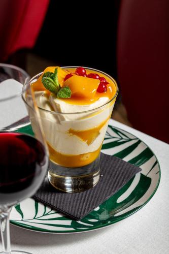 a dessert in a glass sitting on a plate at Château Hôtel Du Colombier in Saint Malo