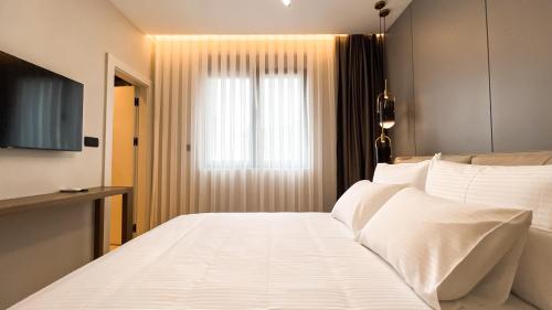 Ένα ή περισσότερα κρεβάτια σε δωμάτιο στο Apart hotel Emiia