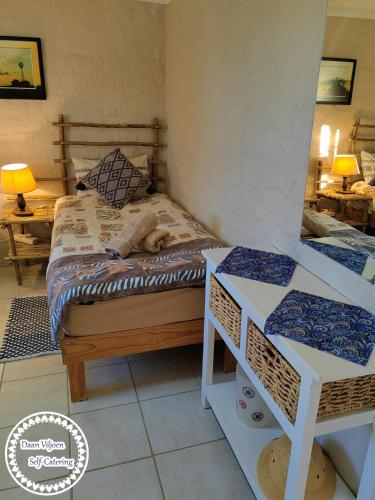 a dog sleeping on a bed in a room at Daan Viljoen Self-Catering in Windhoek