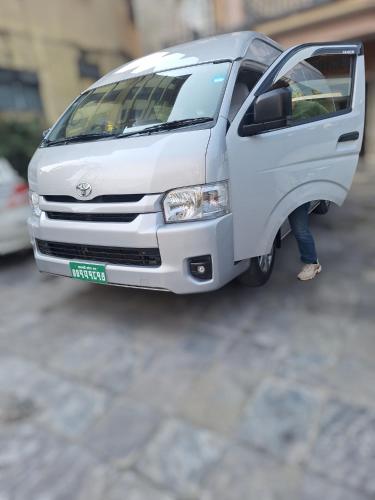 a model of a white van parked on a street at Sedan cab car four wheel jeep in Pokhara