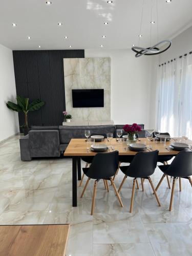 a dining room with a table and chairs and a couch at Podhorský Apartmány Terchová in Terchová