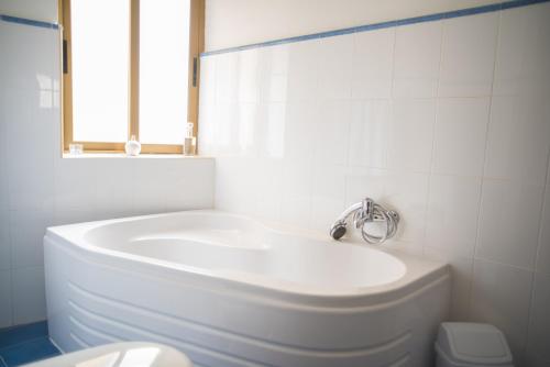 a white bathroom with a sink and a toilet at San Salvatore in St Julian's