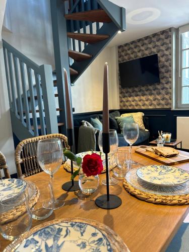 - une table avec des verres à vin et une rose dans l'établissement Le Nid Sainte-Catherine, à Honfleur