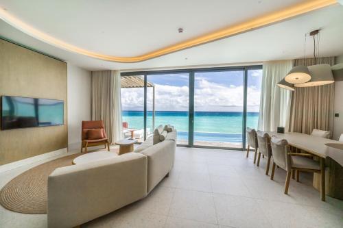 a living room with a view of the ocean at SO/ Maldives in South Male Atoll