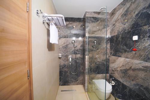 a bathroom with a shower and a toilet at Darin Plaza Hotel in Erbil