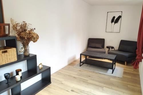 un salon avec deux chaises et une table basse dans l'établissement House with terrace in the heart of Gouvieux, à Gouvieux