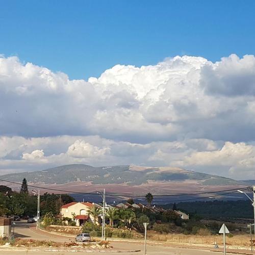 a view of a town and a road with mountains at Casa Gilboa Nirvana Suite נופש בגלבוע in Gan Ner