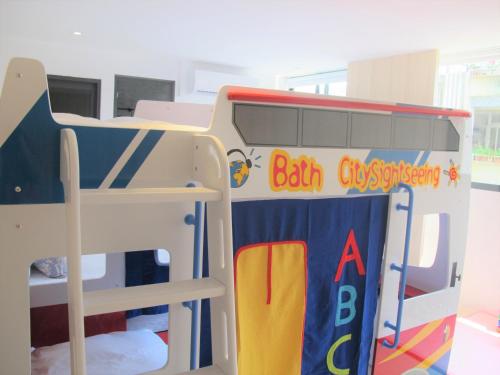 a school bus with a bunk bed in a room at Meng Yun Ge Hotel in Jiaoxi