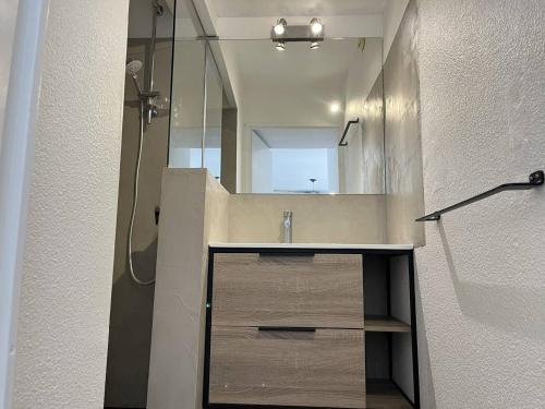 une salle de bain avec une douche, un lavabo et un miroir dans l'établissement CAPAO Joli 2 pièces cabine piscine Richelieu Cap d'Agde, au Cap d'Agde