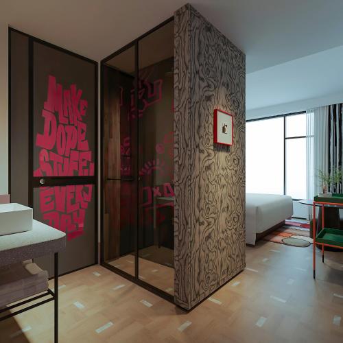 a room with a glass partition with graffiti on the wall at Dali Upland International Youth Hostel, near the south gate of the ancient city ,5 mins walk to the old town, Close to Er Hai Lake, convenient payment and visa cards are accepted in Dali