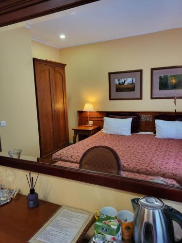 a bedroom with a bed and a desk with a desk at Vila Florena Garden in Palanga