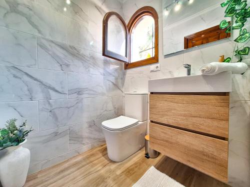 a bathroom with a toilet and a sink at La Karina in Denia