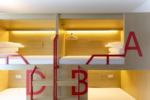 two bunk beds with a large red sign in a room at Dali Upland International Youth Hostel, near the south gate of the ancient city ,5 mins walk to the old town, Close to Er Hai Lake, convenient payment and visa cards are accepted in Dali