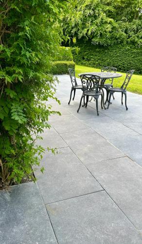 two benches and a table in a park at Beautiful home in Thomastown in Thomastown