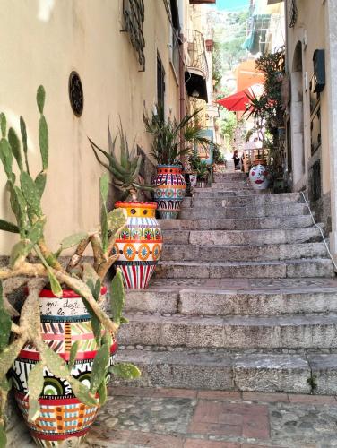 a set of stairs with colorful vases on them at Casa Basilico' Taormina in Taormina