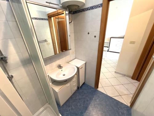 a bathroom with a sink and a mirror at Villa Duna Nord 287 in Bibione