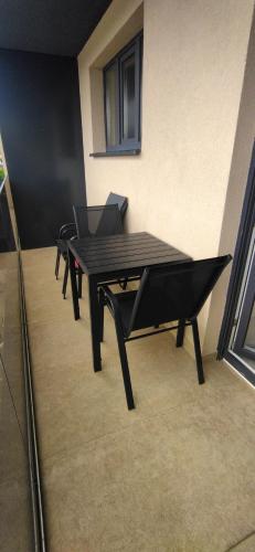 a black table and chairs in a room at Apartman Bonaca in Kiseljak