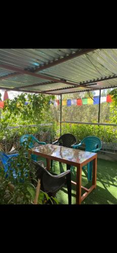 a table and chairs sitting under a tent at Guru guest house in Leh