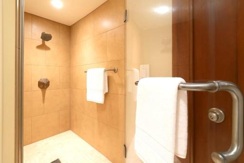 a bathroom with a shower with a glass door at KBM Resorts FREE CAR Beach Villas at Ko Olina BVK-B-308 Beachfront Villa in Kapolei