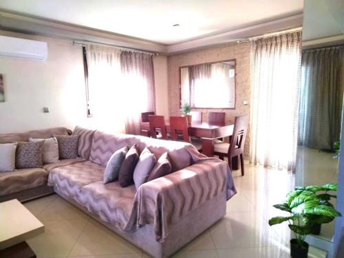 a living room with a couch and a table at Rias house in Néa Péramos