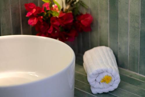 a toilet paper roll sitting next to a cup on a counter at Studios Nelli Alonissos in Patitiri